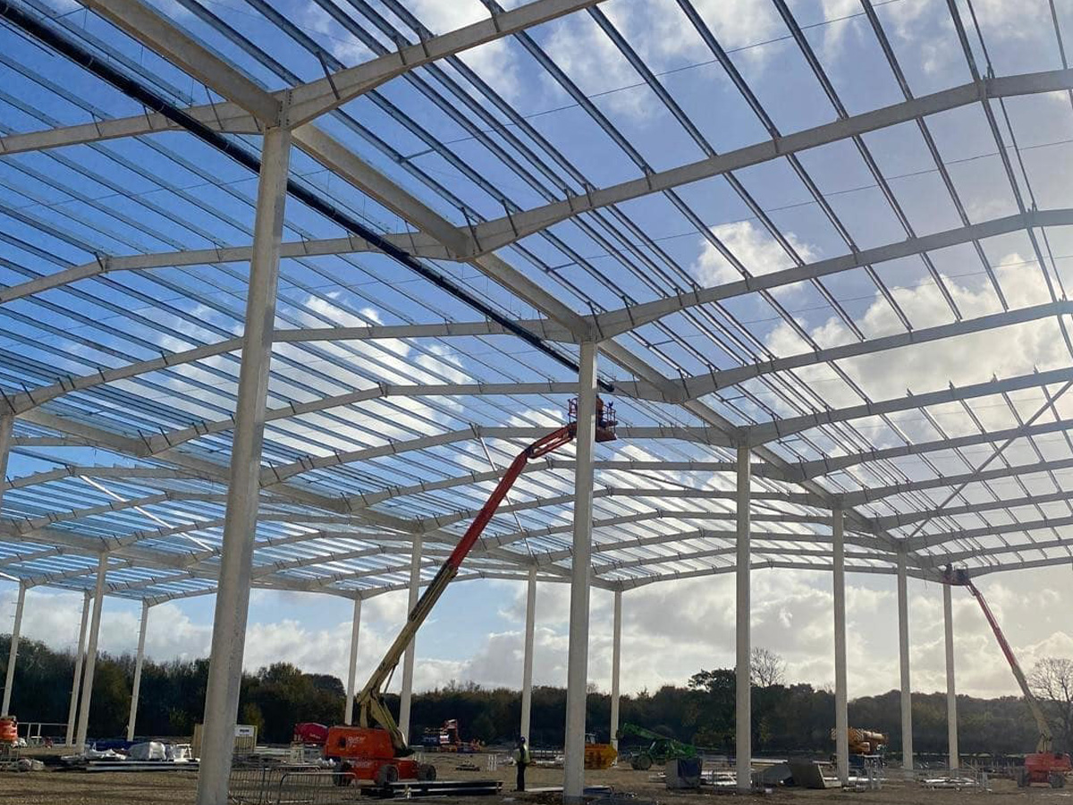Construction site showing the steel frame structure of a large building under construction.