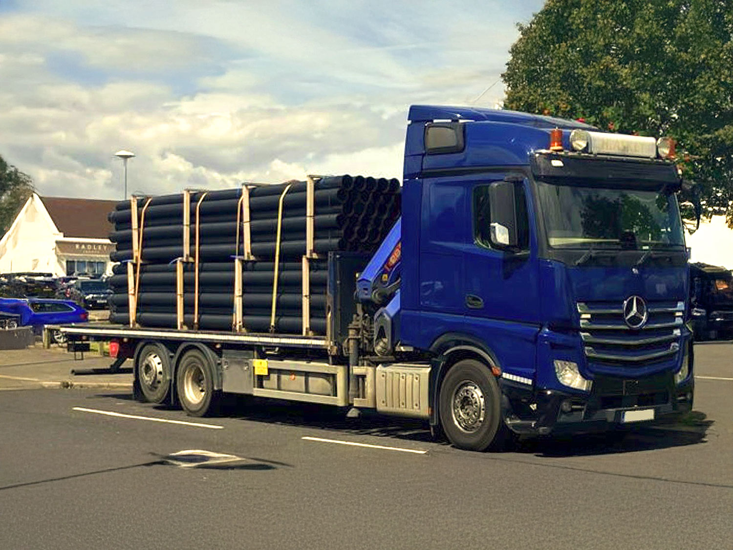 An image of a lorry carrying pipes.